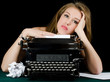 The beautiful girl at a typewriter. A retro style