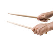 Hands playing with drums sticks on white