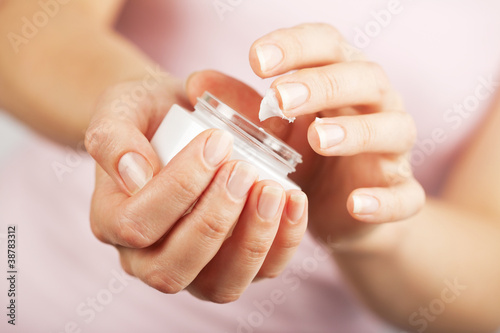 Photo: beautiful woman hands applying cream beautiful woman hands applying cream
