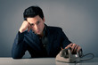 Foto: Man waiting for a phone call against grey background. Man waiting for a phone call against grey background.