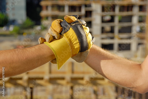 Photo: Handshake over building site Handshake over building site