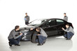 Photo: Insurance agent looking at car Insurance agent looking at car