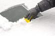 scraping snow and ice from the car windscreen