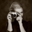 Foto: Woman in classic dress with retro camera. Woman in classic dress with retro camera.