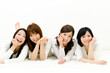 attractive asian women lying on the white carpet