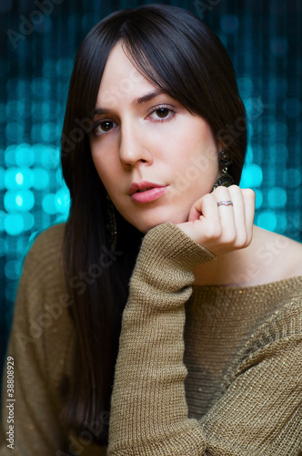 Photo: Attractive girl posing in front of shiny background Attractive girl posing in front of shiny background