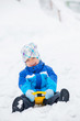 The boy goes for a drive on an snow slope. The boy goes for a drive on an snow slope.