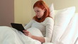 Redhead women in hospital with tablet