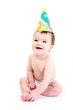 Laughing baby wearing party hat - celebration