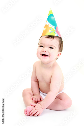 Photo: Laughing baby wearing party hat - celebration Laughing baby wearing party hat - celebration