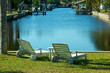 Photo: two empty chairs by the water two empty chairs by the water