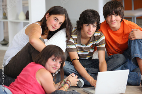 Photo: teenagers having fun with a laptop at home teenagers having fun with a laptop at home