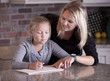 Photo: Mother helping her daughter with homework Mother helping her daughter with homework