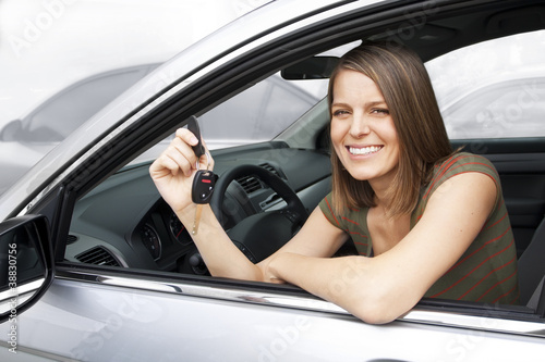 Photo: Happy Woman Renting or Buying a Car Happy Woman Renting or Buying a Car