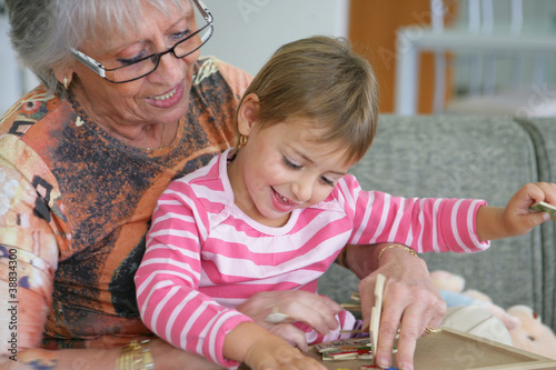 Photo: Grandma and granddaughter playing a game Grandma and granddaughter playing a game
