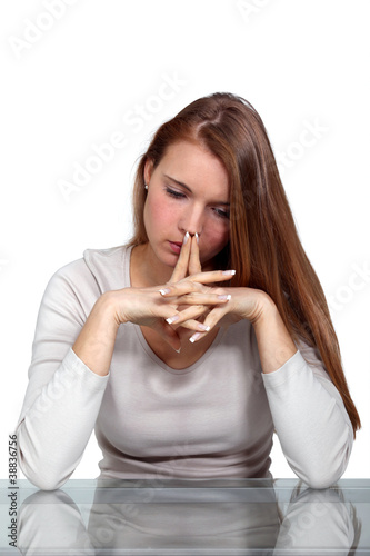 Photo: Pensive woman with her hands to her face Pensive woman with her hands to her face
