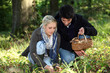Photo: young couple gathering mushrooms young couple gathering mushrooms