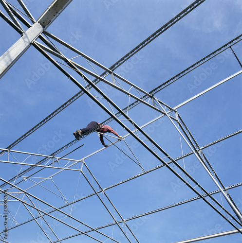 Photo: Construction worker building a glasshouse Construction worker building a glasshouse