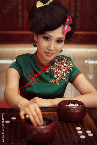 Photo: Woman playing chess Woman playing chess