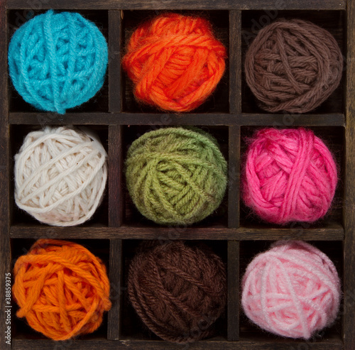 Photo: Nine colorful balls of yarn in printers box Nine colorful balls of yarn in printers box