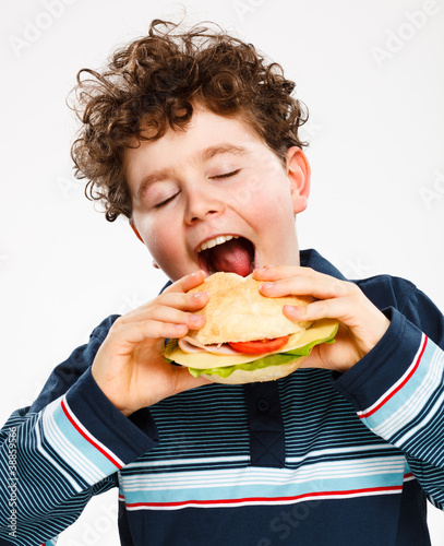 Photo: Boy eating big sandwich Boy eating big sandwich
