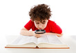 Boy looking through magnifying glass isolated on white
