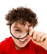 Boy looking through magnifying glass isolated on white Boy looking through magnifying glass isolated on white