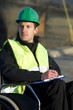 Supervisor Writing On Notepad At Site