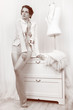 retro fashion beauty woman as sewer near dummy