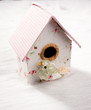 bird in a nest fabric house with round window