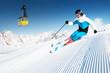 Skier in mountains, prepared piste and sunny day