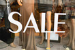 Sale sign in a fashion shop window