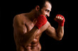 Foto: Young Boxer fighter over black background Young Boxer fighter over black background