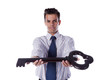 Businessman holding a giant key.. Businessman holding a giant key..