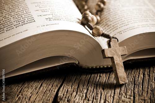 Photo: wooden rosary on the open Bible wooden rosary on the open Bible