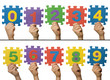 Children hands holding numbers. White isolated multicolor number Children hands holding numbers. White isolated multicolor number