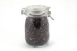 Whole grain black rice in a jar on white background, isolated