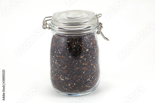 Photo: Whole grain black rice in a jar on white background, isolated Whole grain black rice in a jar on white background, isolated