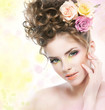 Photo: Pretty young woman touching her beautiful face. Bright makeup Pretty young woman touching her beautiful face. Bright makeup