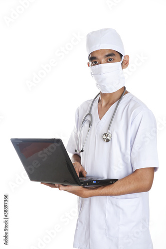 Photo: Doctor with laptop over white background Doctor with laptop over white background