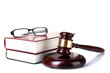 wooden gavel, glasses and books isolated on white