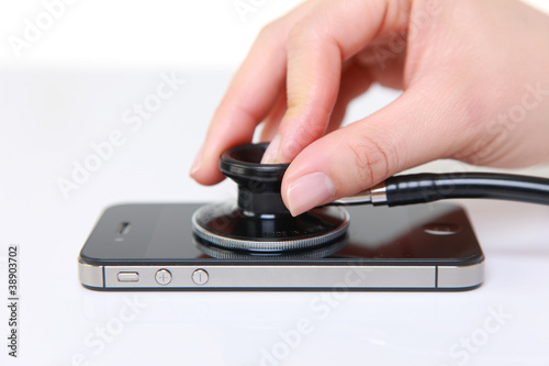 Photo: doctor examines a smart phone doctor examines a smart phone
