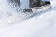 Photo: Snow flying from braking, ice skates blurred Snow flying from braking, ice skates blurred