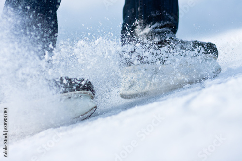 Photo: Two breaking ice skates with flying snow Two breaking ice skates with flying snow