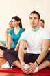 group of young people stretching in aerobics class