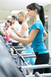 people in gym on treadmill running