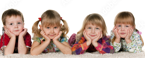 Photo: Four children lying on the carpet Four children lying on the carpet