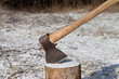 Photo: Axe and log in winter forest Axe and log in winter forest