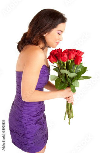 Photo: Woman Holding and Smelling Roses Woman Holding and Smelling Roses