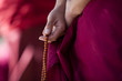 Prayer beads in monk's hand